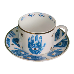 A blue and white Hamsa Blessings Set cup and saucer.